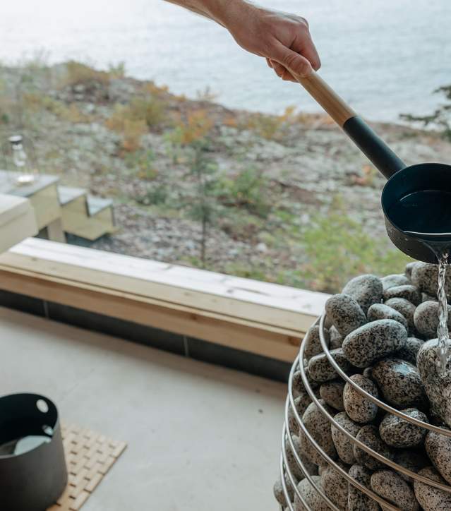 Water is poured over rocks in traditional Finnish sauna.