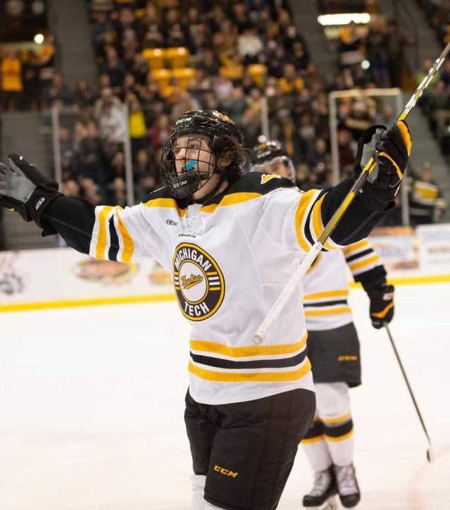 Hockey player acknowledges crowd during a game in a celebratory way.