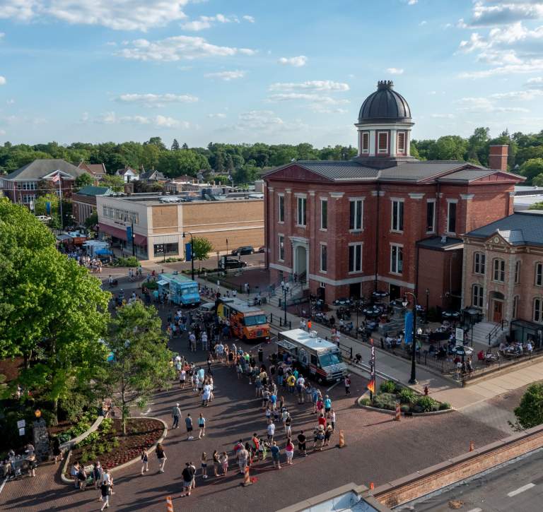 Aerial Photo of the Old Courthouse Center with food trucks lined up and crowds of people on the square.