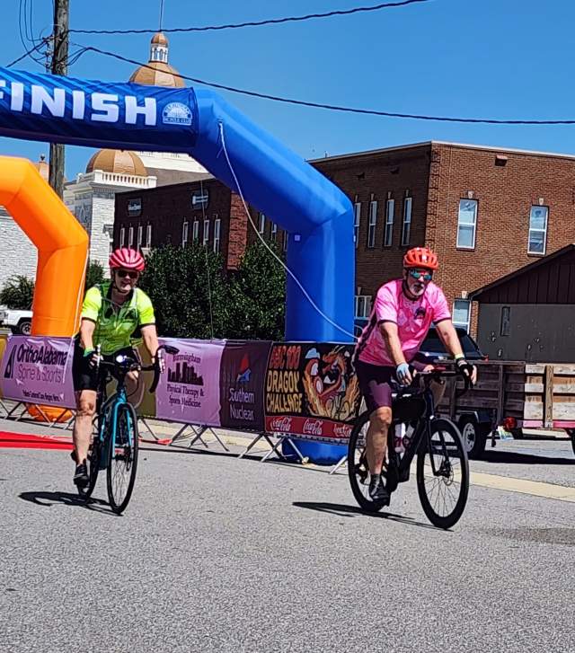 Two bikers come through the finish line during a road race.