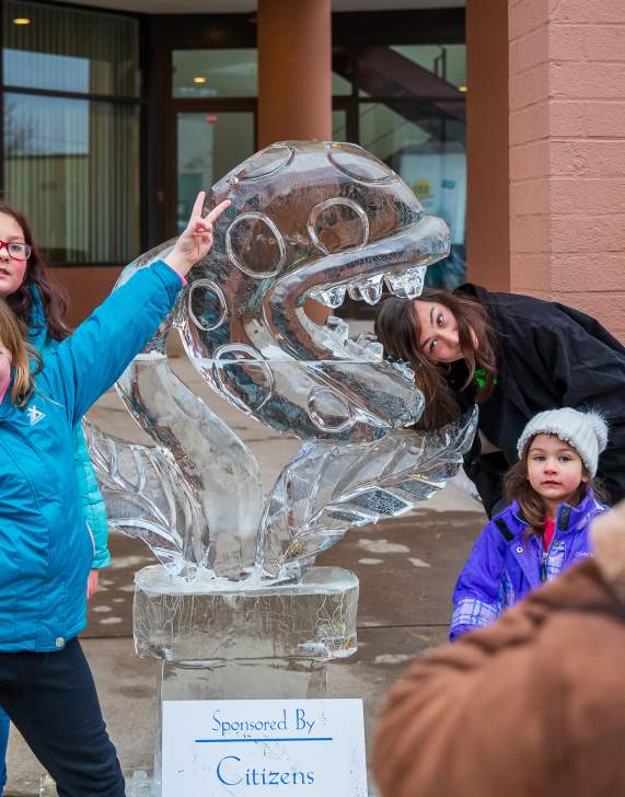 People posing for pics in front of sculptures at the Clarks Summit Festival of Ice