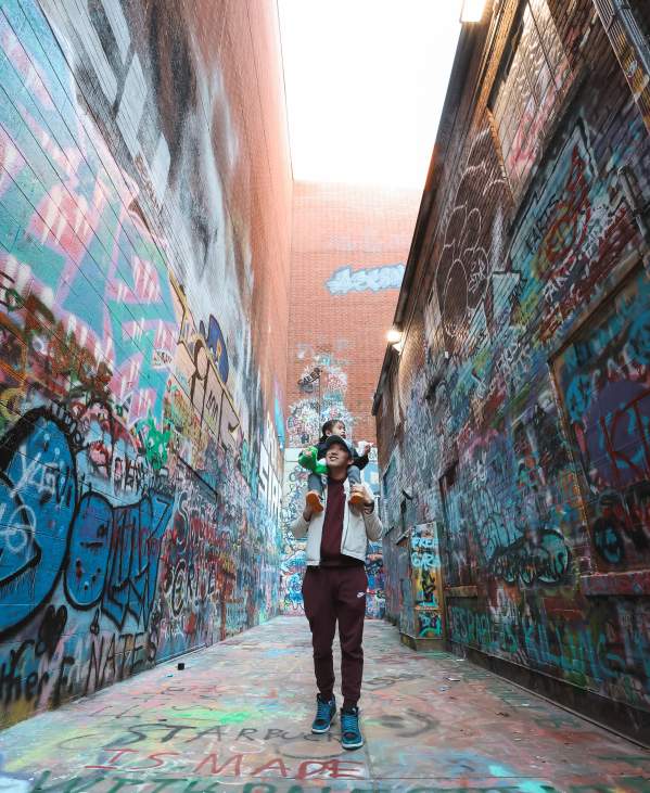 Father with son on shoulders in Graffiti Alley