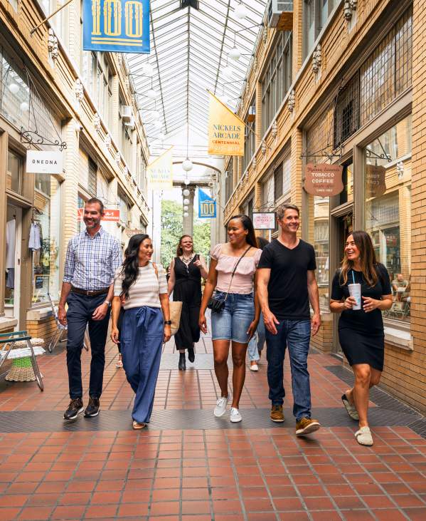 Group of professionals walking through Nickels Arcade covered walkway