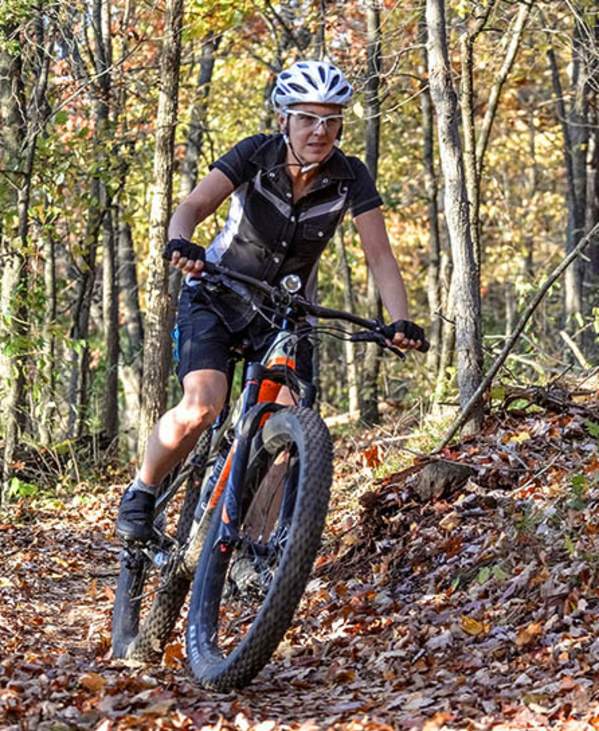 Woman mountain biking in the fall