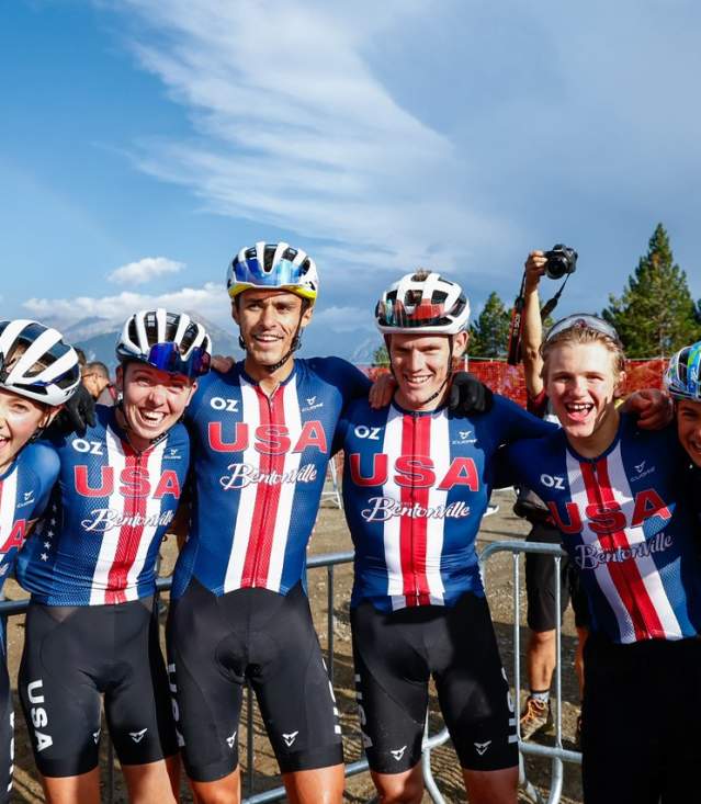 Team USA cyclists wearing Bentonville jerseys celebrating after a race, showcasing unity and excitement.