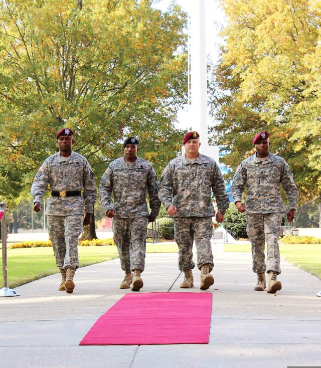 Four US military soldiers walking together