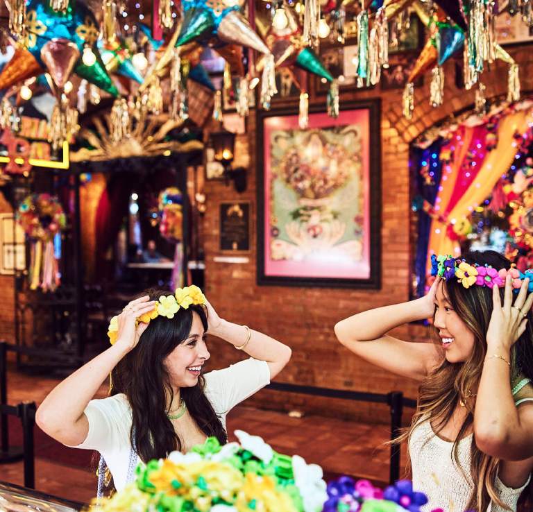 Two girls wearing flower crowns
