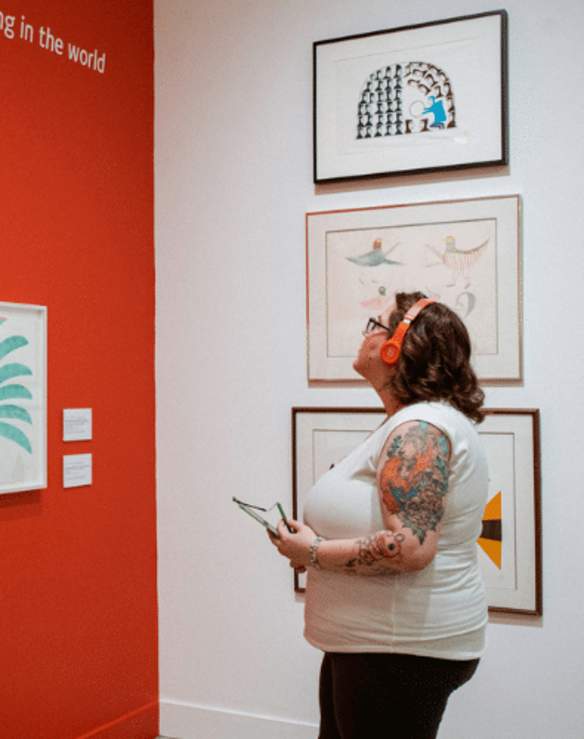 A person viewing different piece of art at the Nanaimo Art Gallery.
