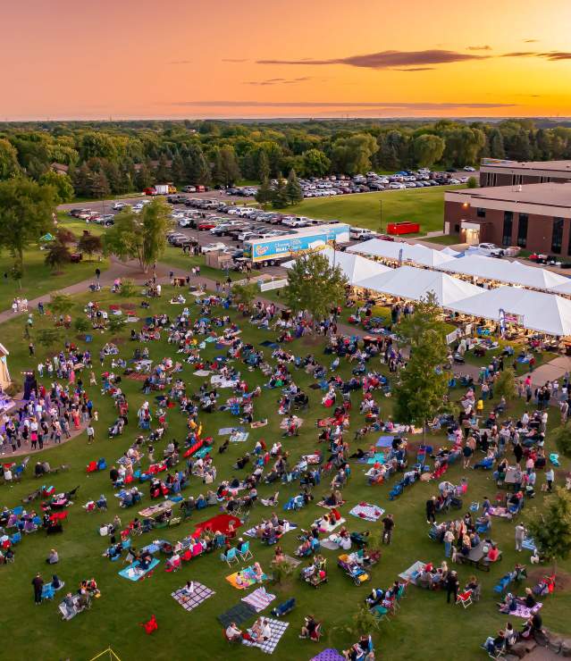 Aerial photo at sunset with live band performing at bandshell in front of hundreds of people at Woodbury Days.