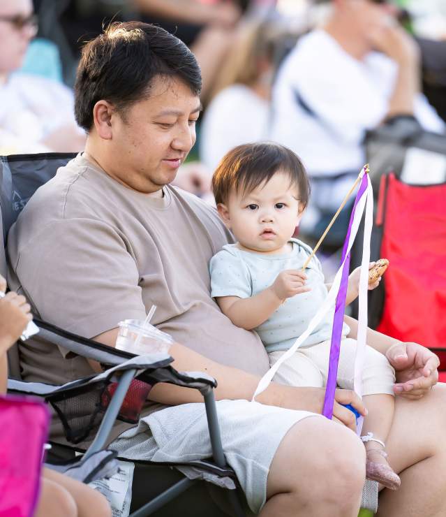 Father and young kids enjoying a festival in Woodbury