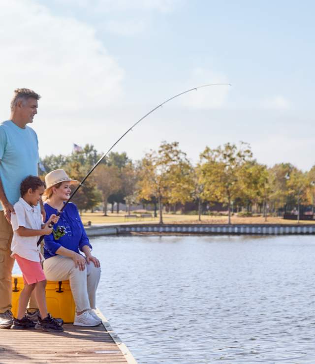two grandparents fish with their grandson at prien lake park