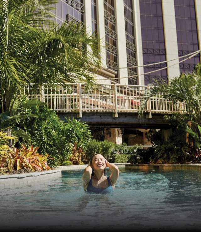 woman swimming in l'auberge pool with today show logo in the bottom corner