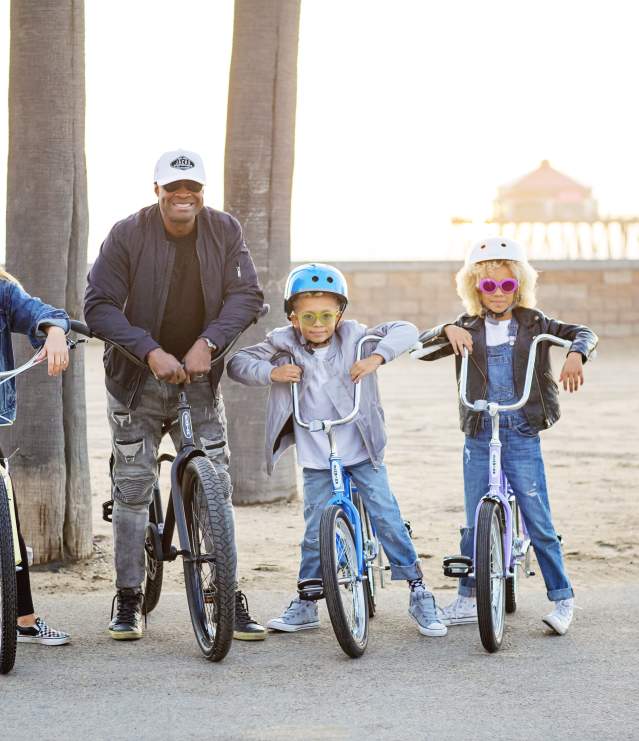 Biking in Huntington Beach | Family on a bike with the pier in the back