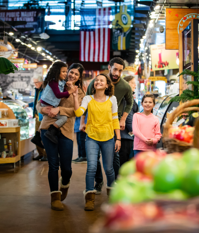 a family walking through the Milwaukee Public Market