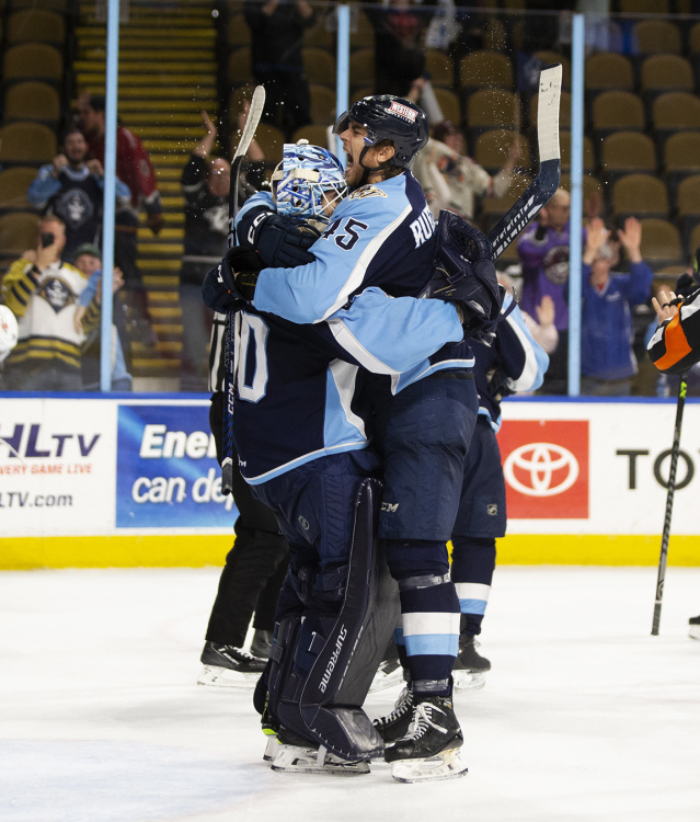 Admirals players hugging and cheering
