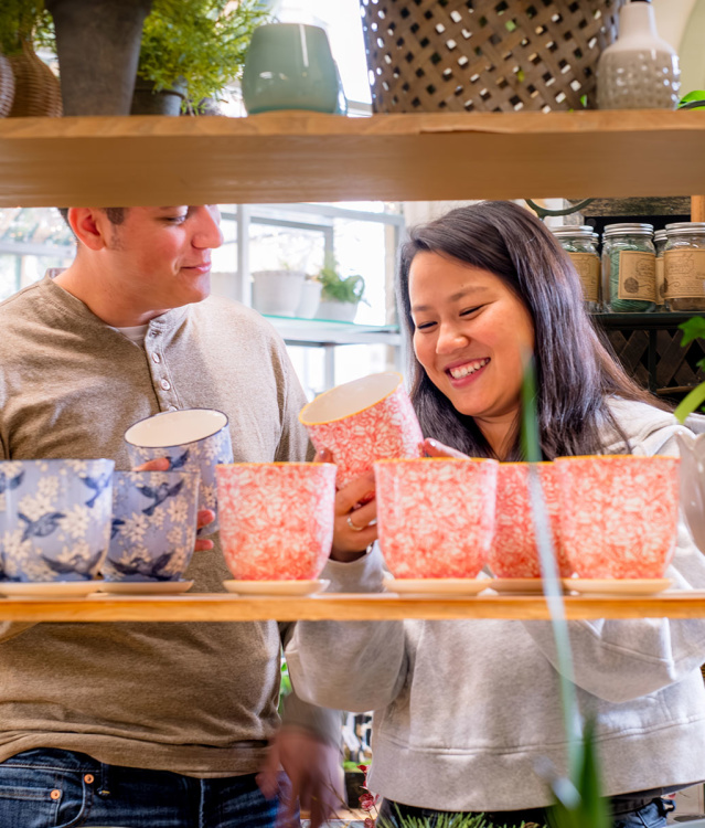 couple looking at colorful plant pots