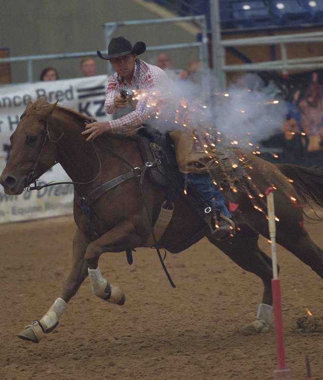 man shooting target while riding horse at the cowboy mounted shooting world finals