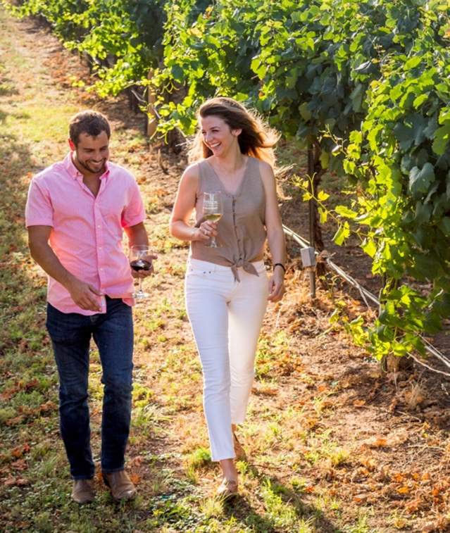 Couple walking in vineyard wide