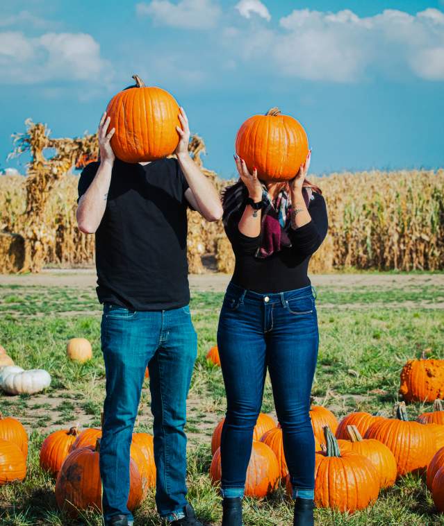 Couple holding pumpkins
