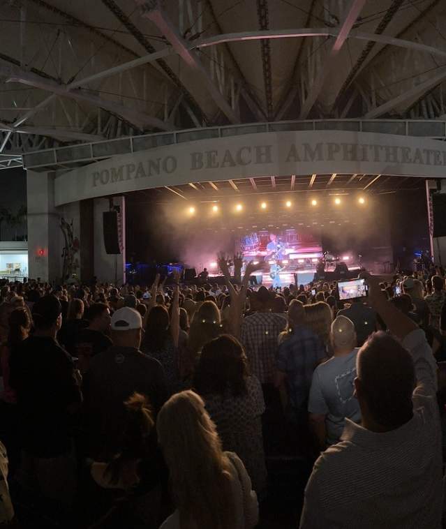 A crowd as seen from the back row, attending an evening concert at the Pompano Beach Amphitheater.