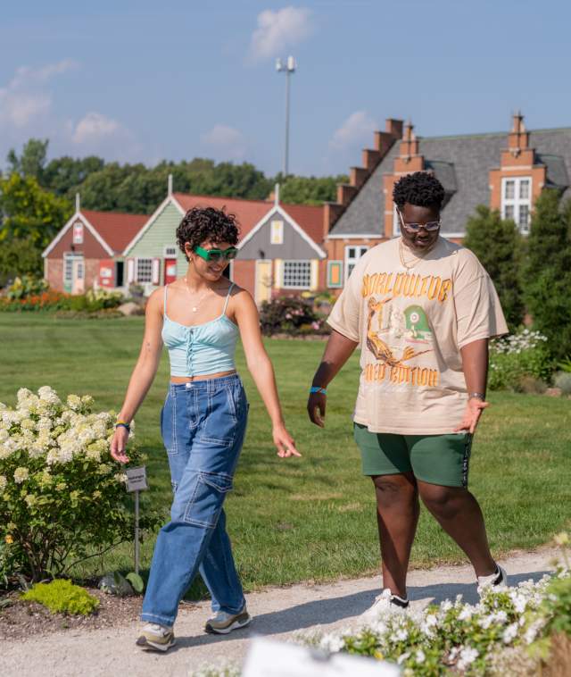 Young Adults Walking Through the Flowers at Windmill Island Gardens