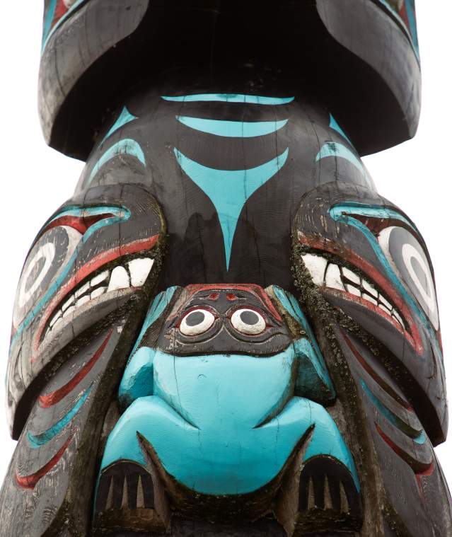 A close-up shot of a black, red, and blue totem pole.