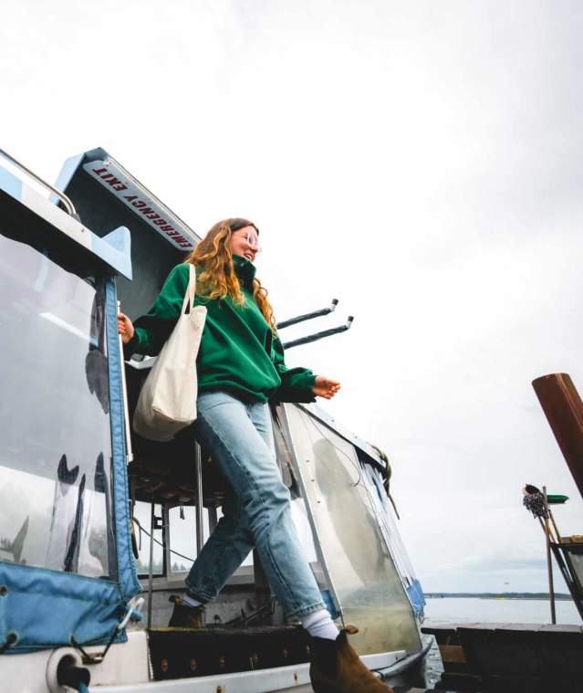 A women existing a small ferry.