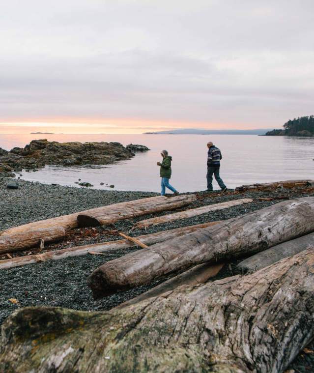 A couple walking on the beach at Pipers Lagoon.