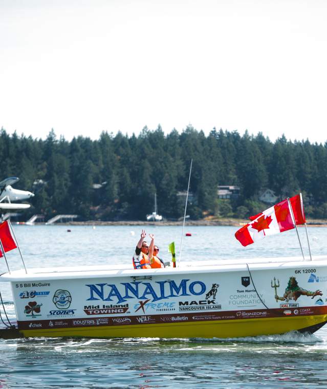 A bathtub boat being raced.