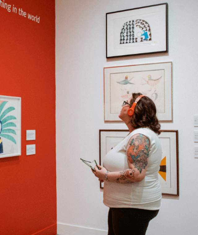 A person viewing different piece of art at the Nanaimo Art Gallery.