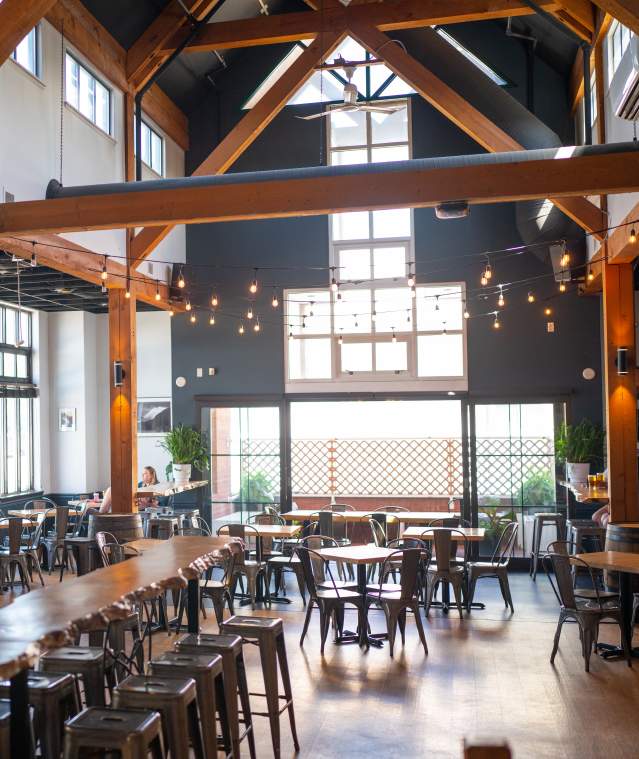 The inside of White Sails Brewery, rustic with high ceilings a plenty of natural light.
