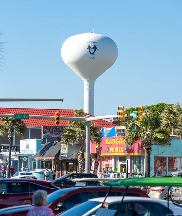 A photo of a water tower on Main Street displaying the iconic Shag logo or two dancers