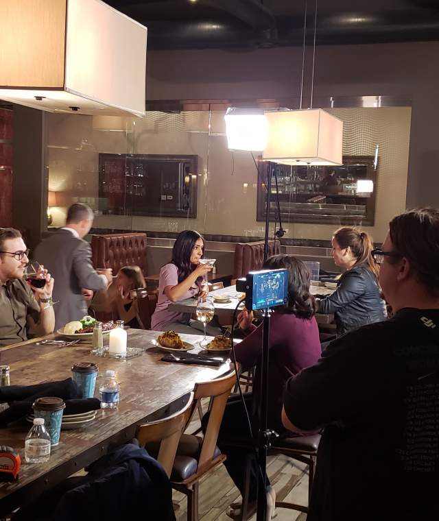 Crew filming in modern restaurant