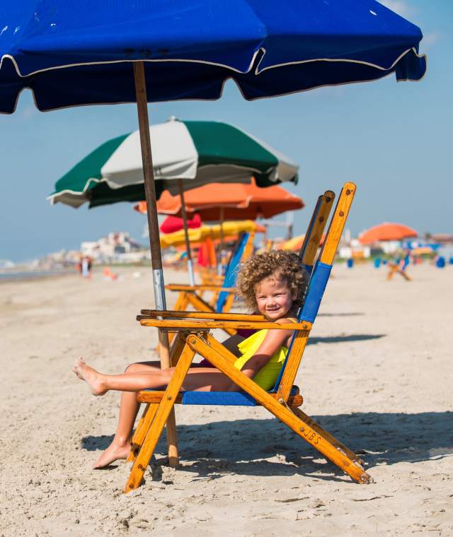 Kids enjoying the beach chairs along Stewart Beach in Galveston, TX