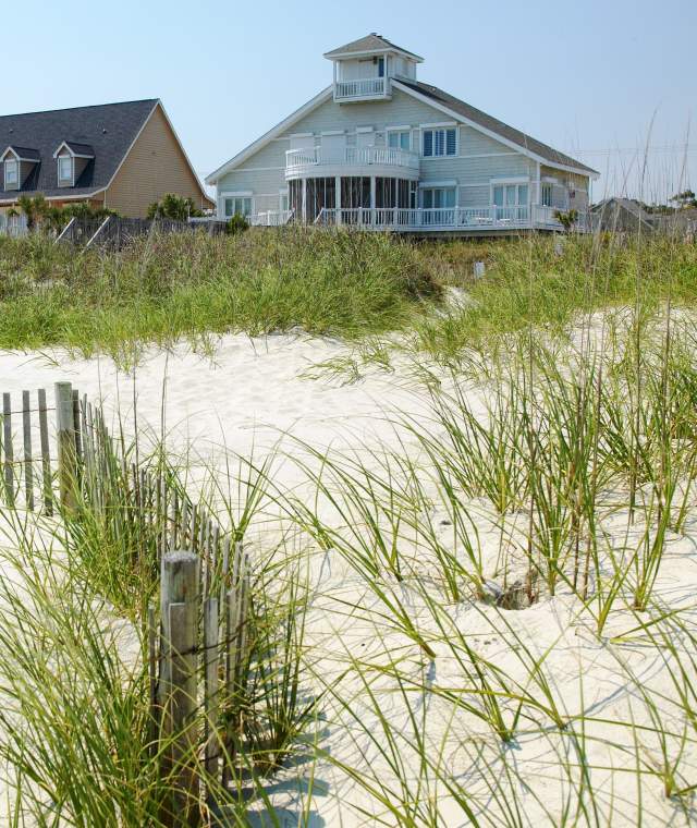 Beach houses sit behind sand dunes in North Myrtle Beach