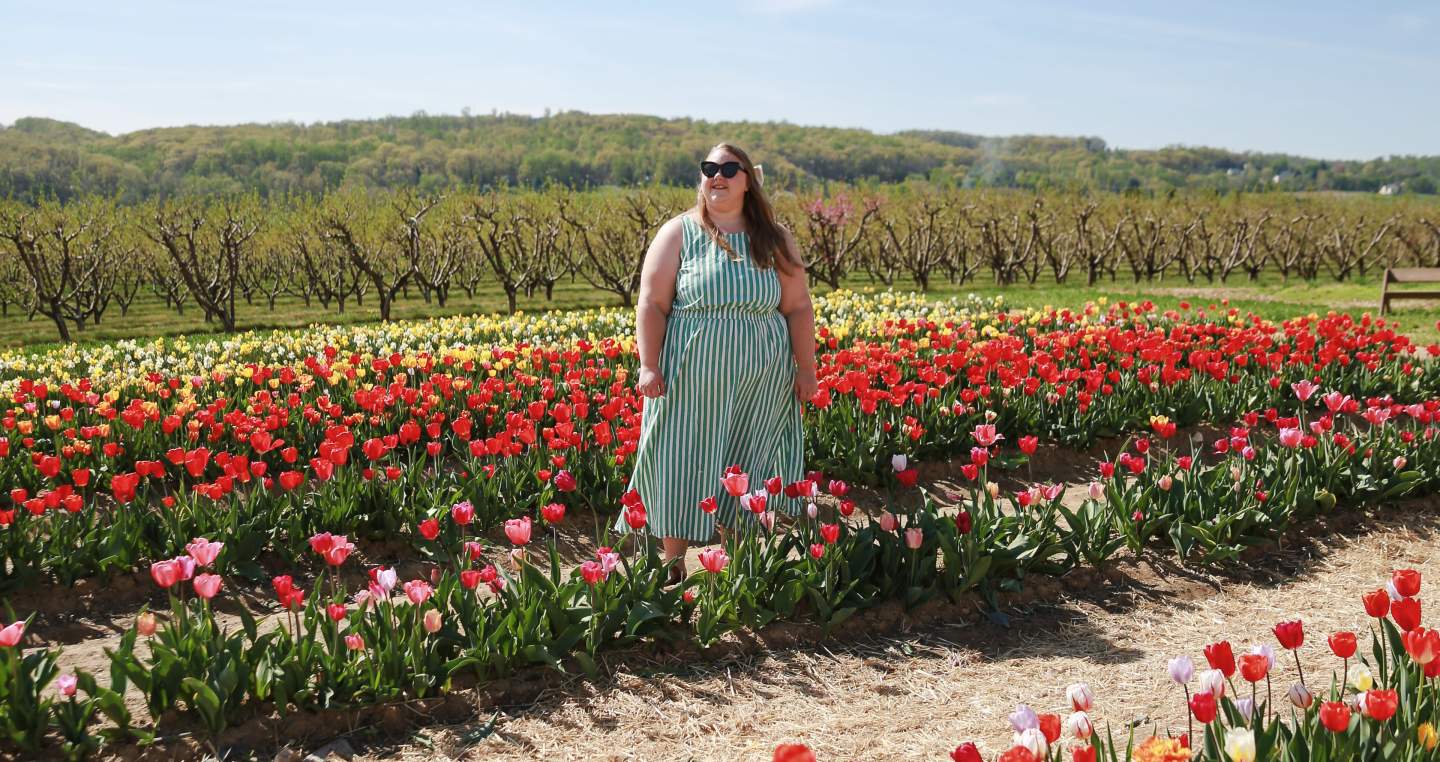 woman enjoying the colorful tulip field at Flinchbaugh's