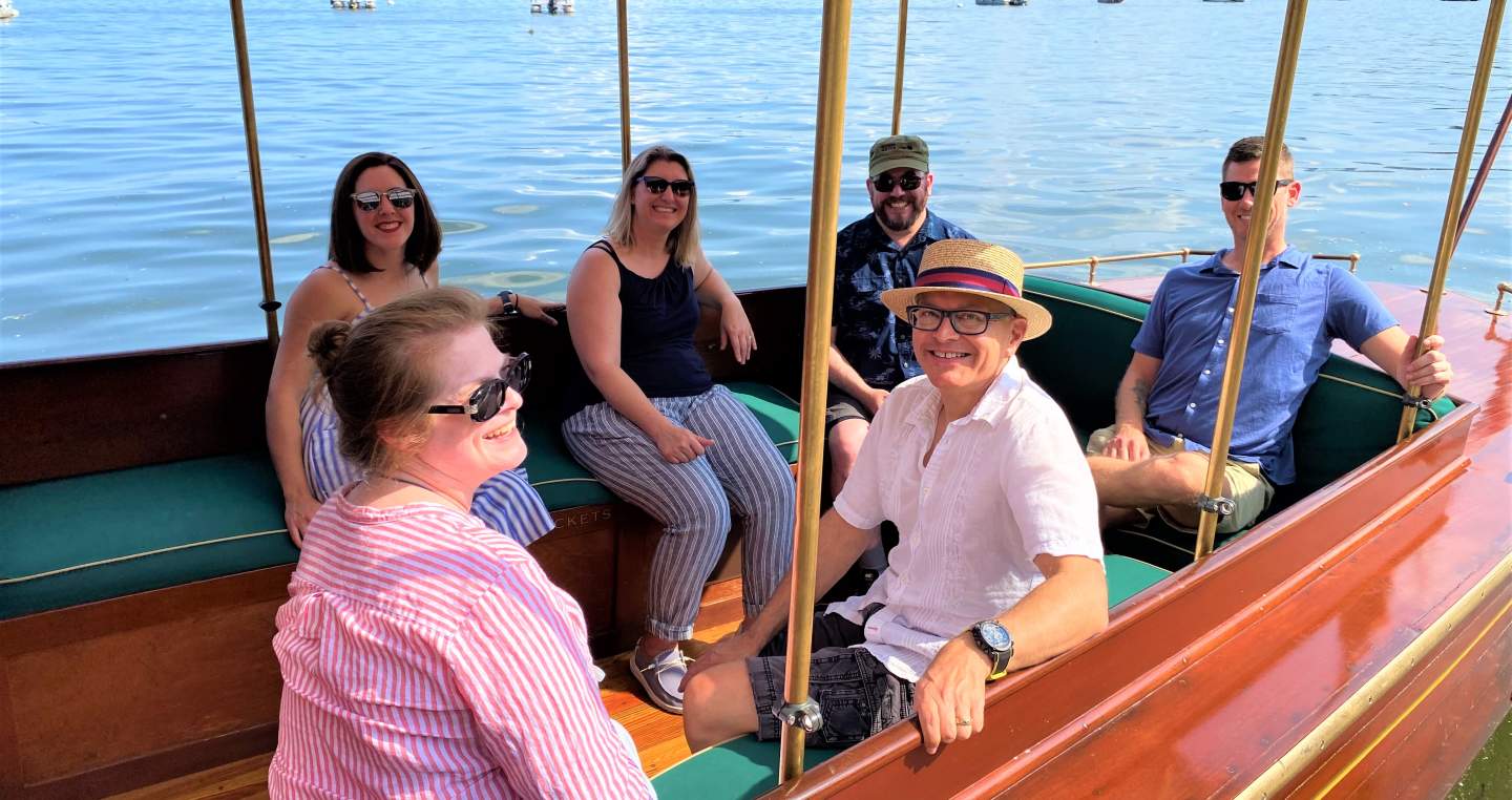 a group of people smiling and having fun aboard the Chief Uncas