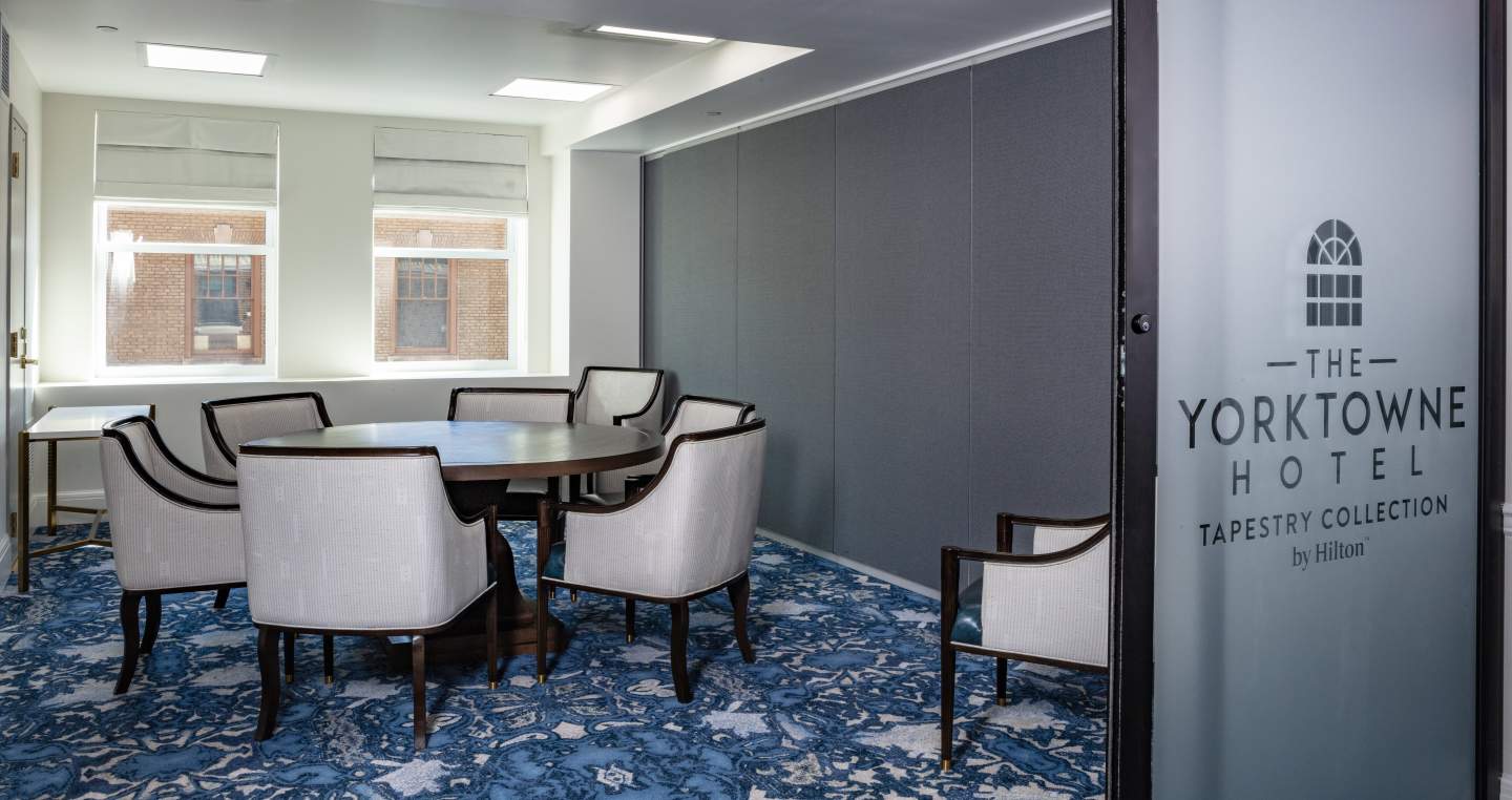 Meeting room with chairs at a round table in the Yorktowne Hotel