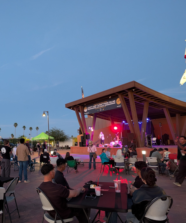 Image showing a crowd of people gathered around the stage at Freedom Plaza in downtown Twentynine Palms, California, at a Twentynine Palms Levitt AMP Music Series concert.