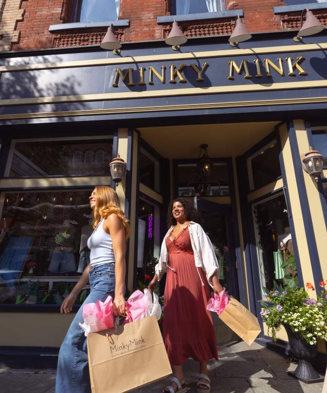Women leaving Minky Mink with shopping bags