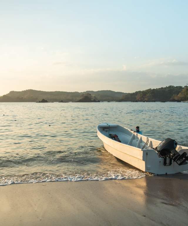 A small fishing boat in the shores of a calm beach at Cerro Hoya