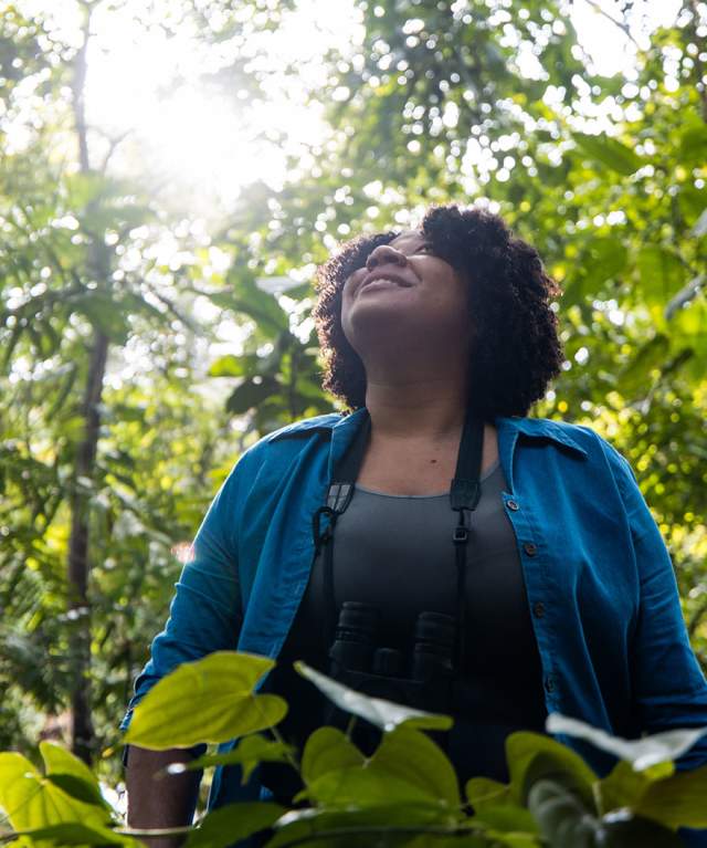 Tourist crossing the Las Tablitas trail surrounded by leafy trees