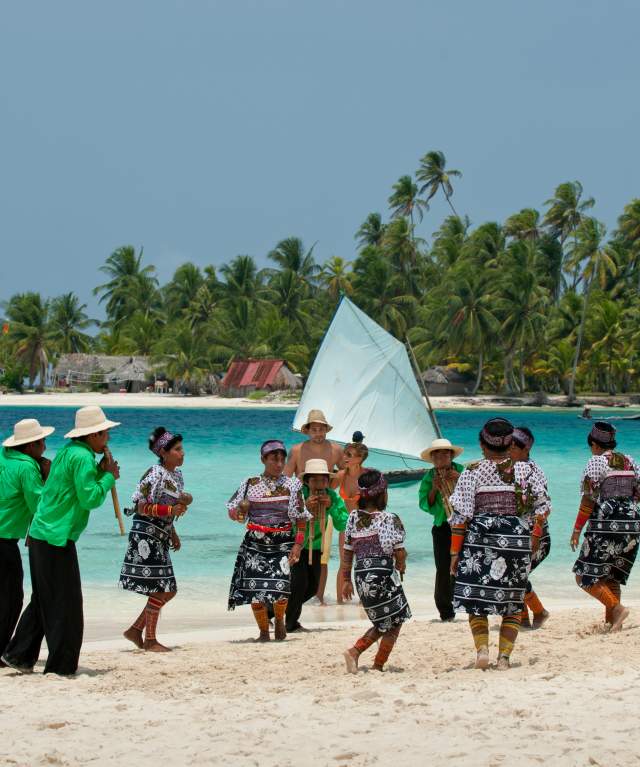 Guna Dule community performing a traditional dance on a beach in San Blas, Panama
