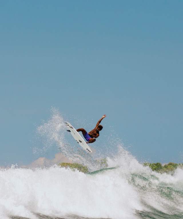 Surfer performing an aerial maneuver on a wave along Veraguas’ Pacific Coast, Panama