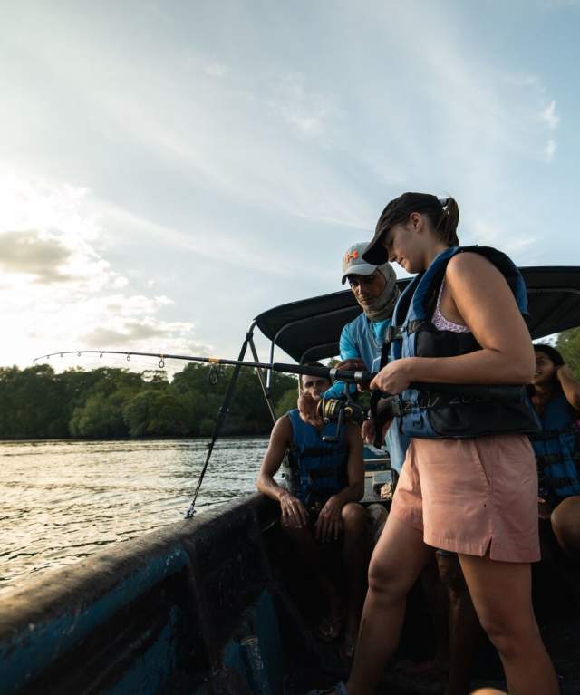 Group of tourists on a boat learning how to fish along the Pacific Coast of Panamá.