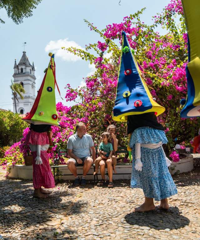A festive occasion characterized by people donning costumes of small individuals with oversized headwear at la Villa de Los Santos