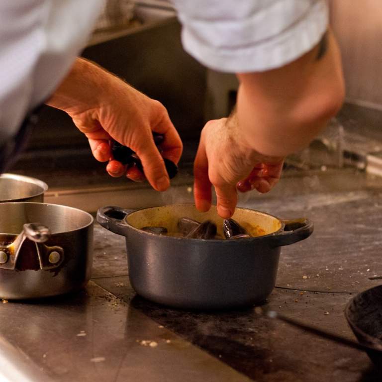 A chef at ABar Bistro in Portsmouth prepares a meal