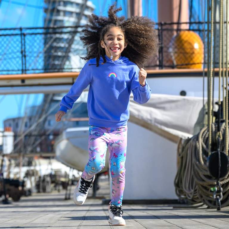 Photograph showing two young children running along the main deck of HMS Warrior at Portsmouth Historic Dockyard