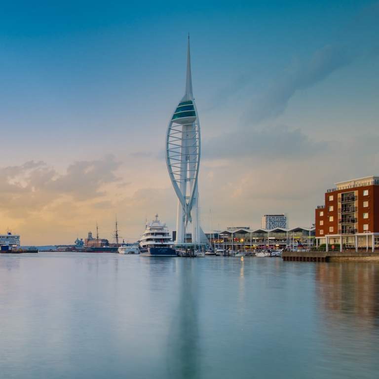 Wide-angle photograph showing Spinnaker Tower and very still waters of Portsmouth Harbour