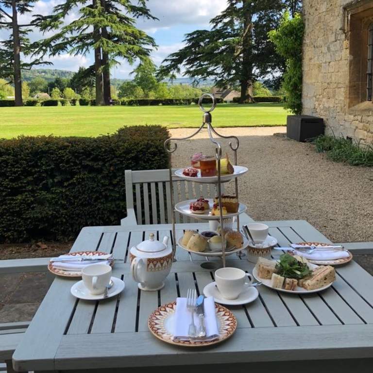 Afternoon tea setup on a table in the gardens at Ellenborough Park